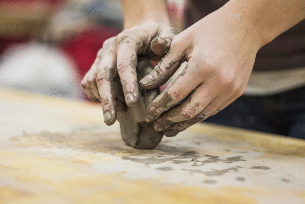 How to Make Money as an Artist Online in 2025: Full Guide 2 Someone shaping clay showing how to make money as an artist online.