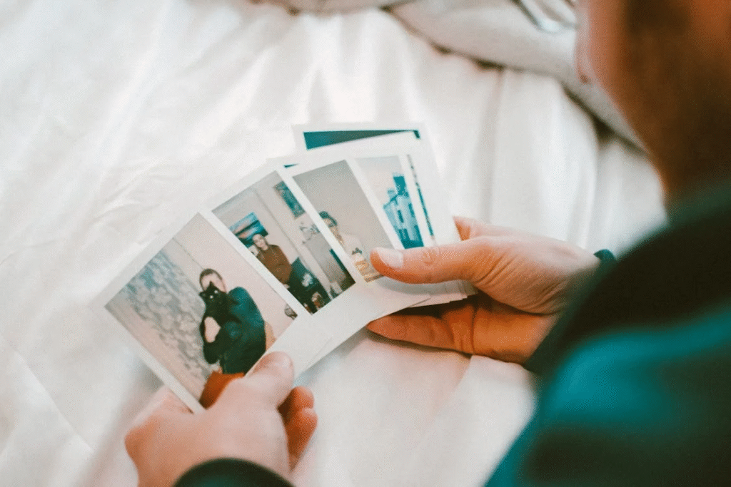 Someone looking at polaroids while thinking about the best hooks for TikTok videos.