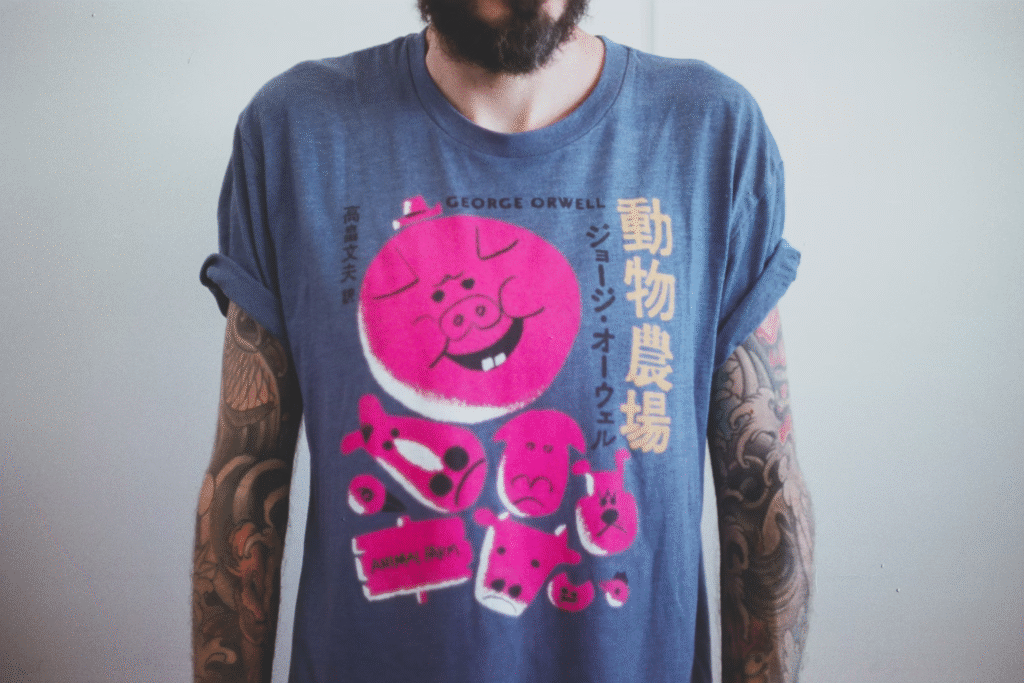 5 T-Shirt Printing Tips & Tricks for Your Clothing Brand 1 A man wearing a t-shirt print from a t-shirt printing service.