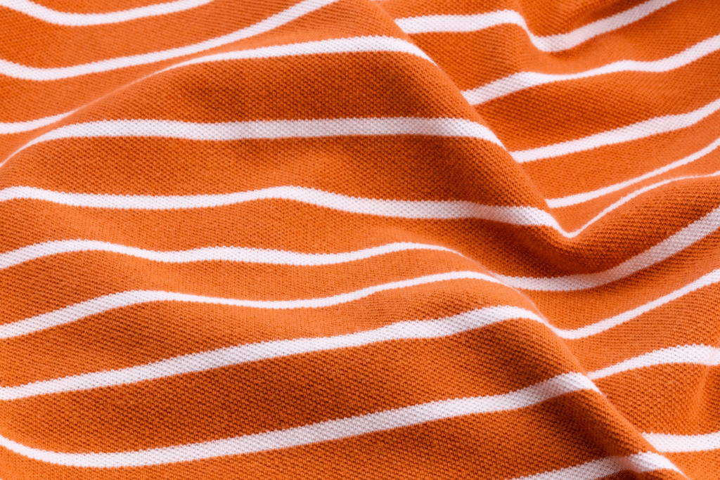 5 T-Shirt Printing Tips & Tricks for Your Clothing Brand 2 Striped white and orange fabric for t-shirt printing.