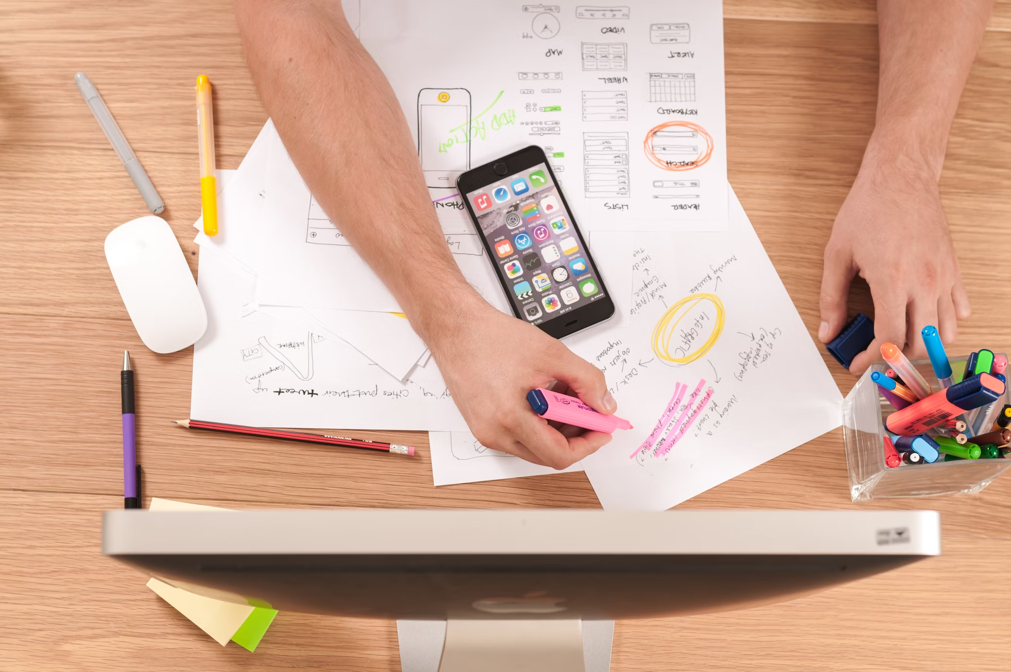 A person highlighting and taking notes for the ultimate marketing calendar in 2025.