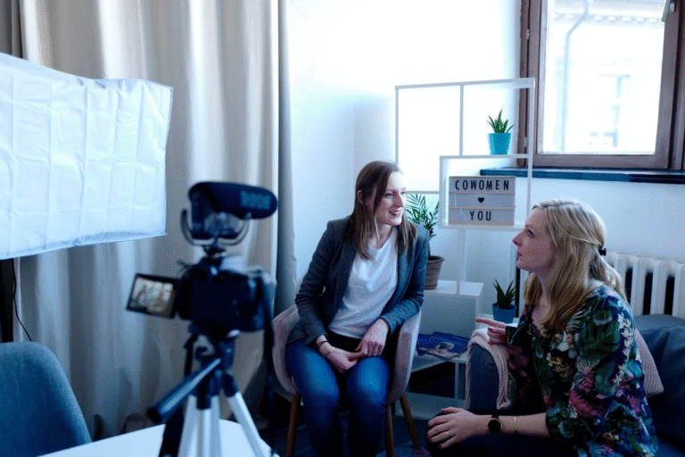 Two women recording themselves during an interview showcasing incorporating branding into video content.