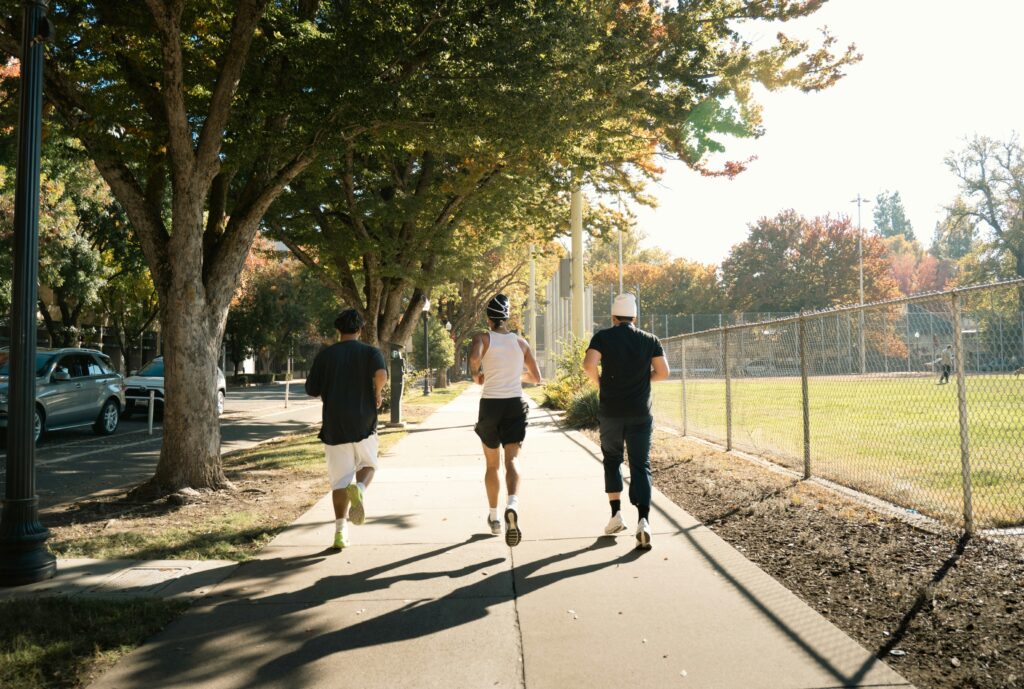 Three people running while wearing negative ion fabric for their health.